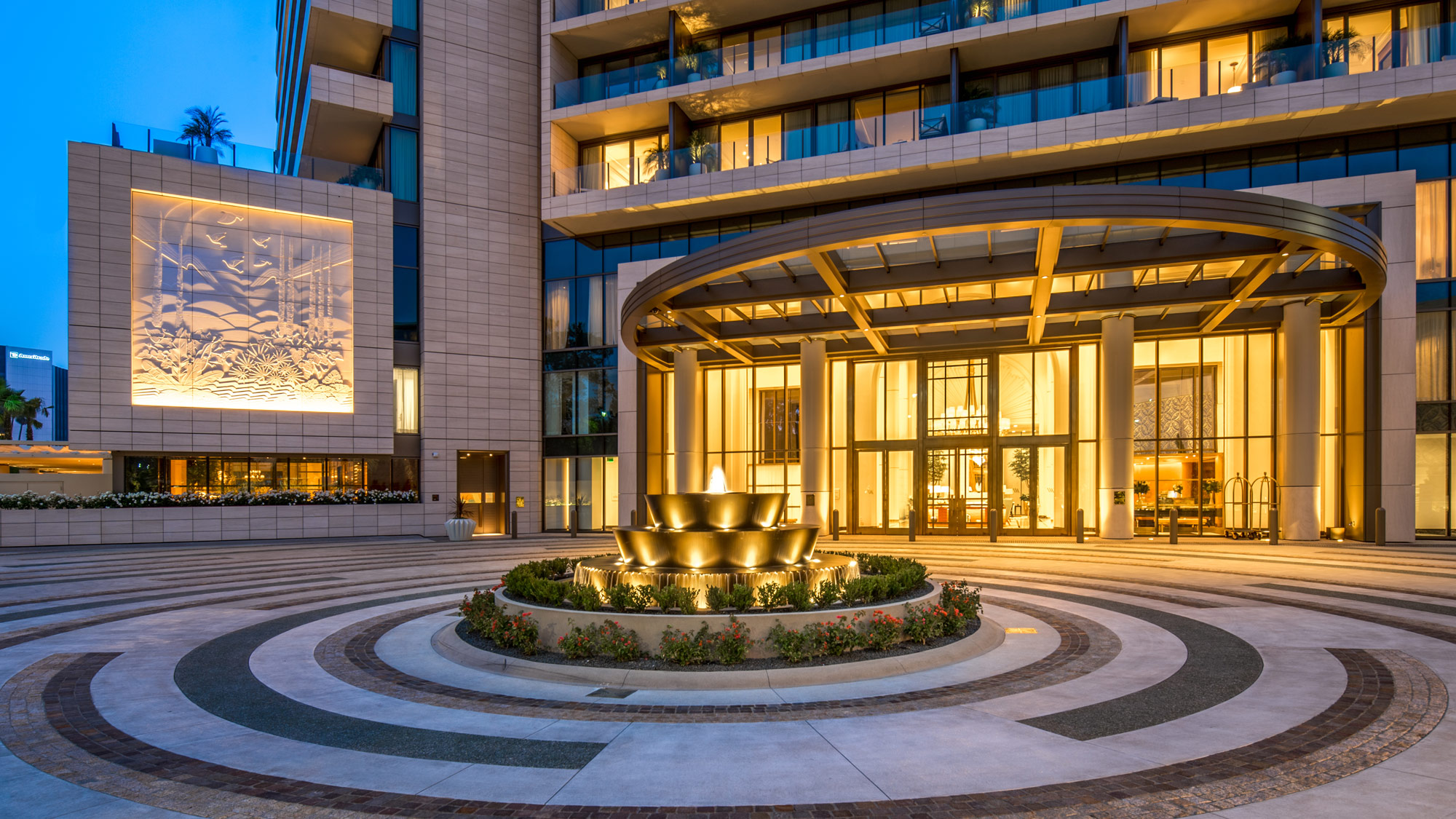 A building with a fountain in front.
