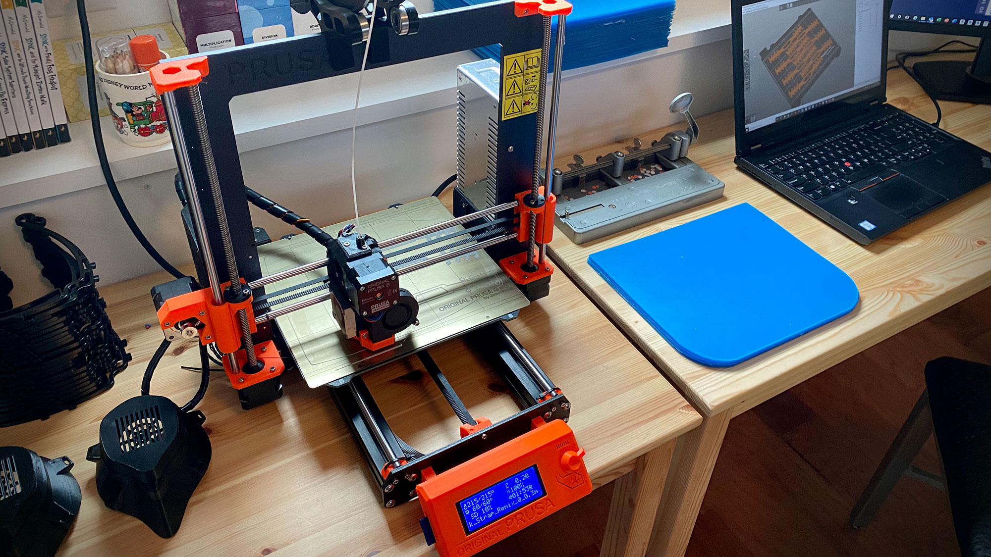 A table with a laptop and other objects on it.