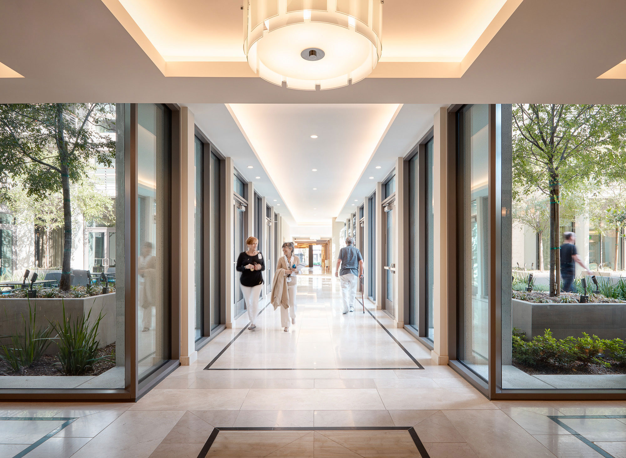 A group of people walking through a building.