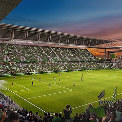 A football stadium with a crowd watching.