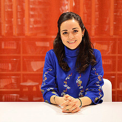 A woman sitting at a table.