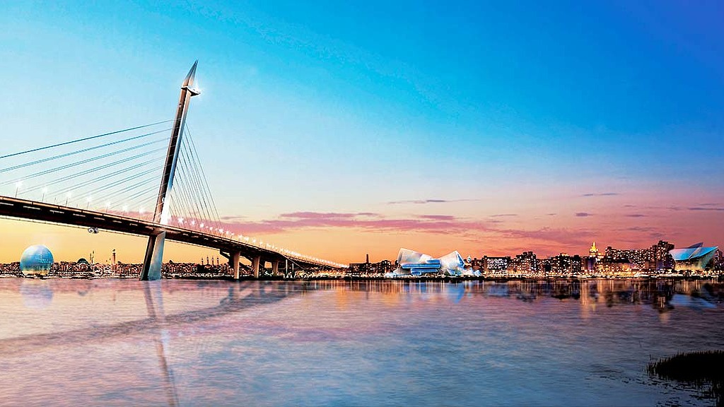 A bridge over water with a city in the background.