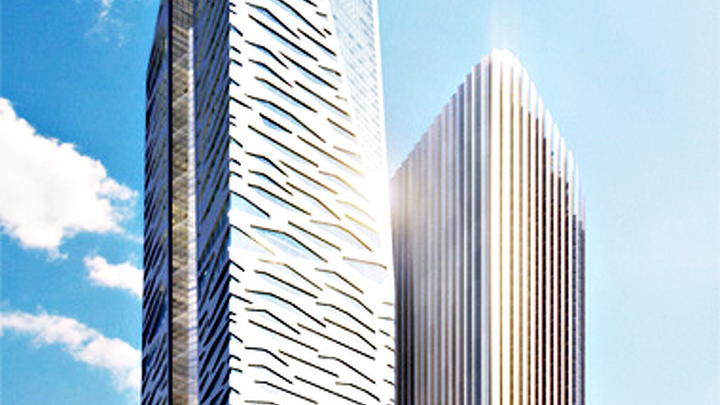 A few skyscrapers against a blue sky.