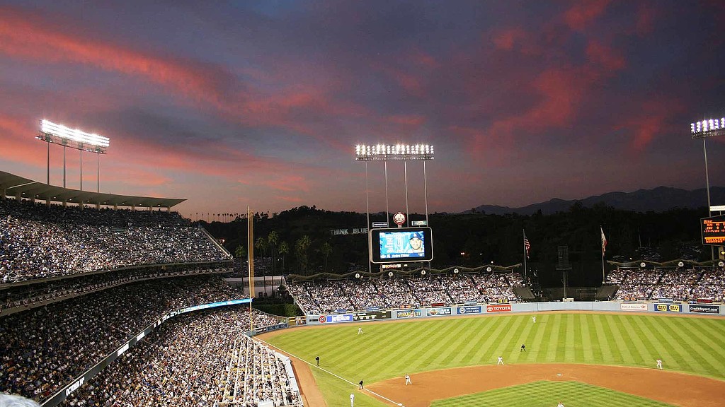 A baseball field with a crowd watching.
