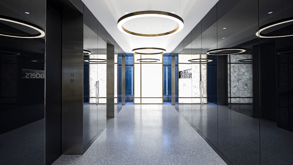A long hallway with blue doors.