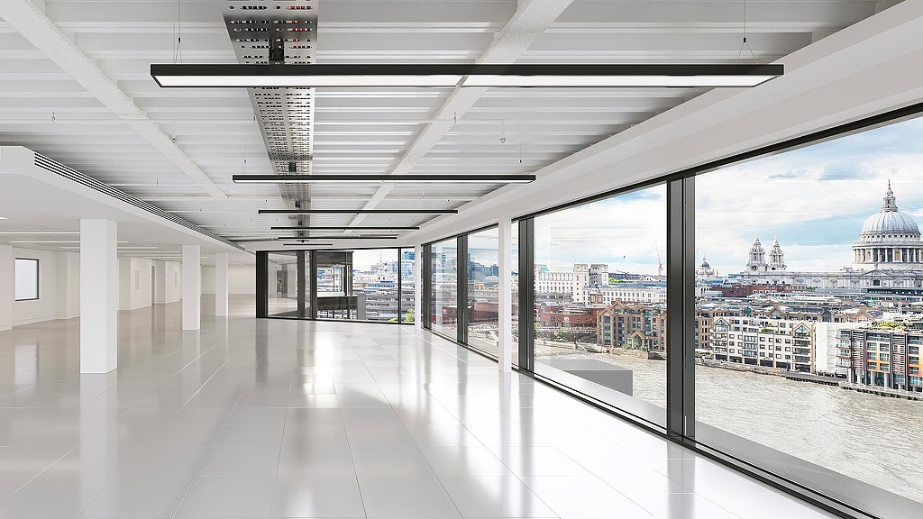 A large room with windows and a view of a city.