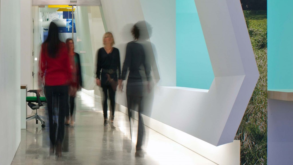 A group of people walking in a hallway.