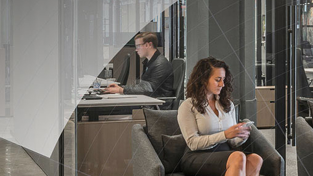 A man and a woman sitting at a desk.