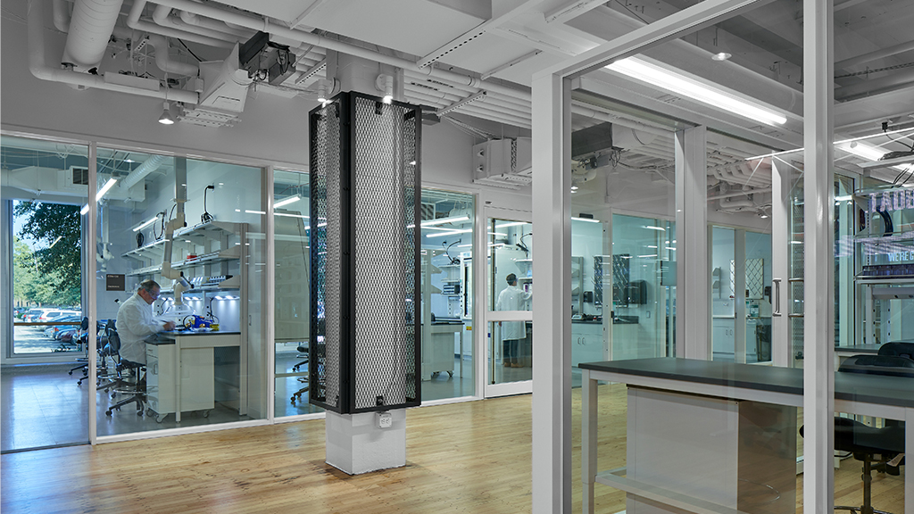 A room with glass walls and a large black object in it.