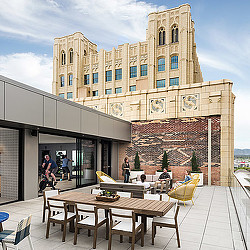 A building with tables and chairs outside.