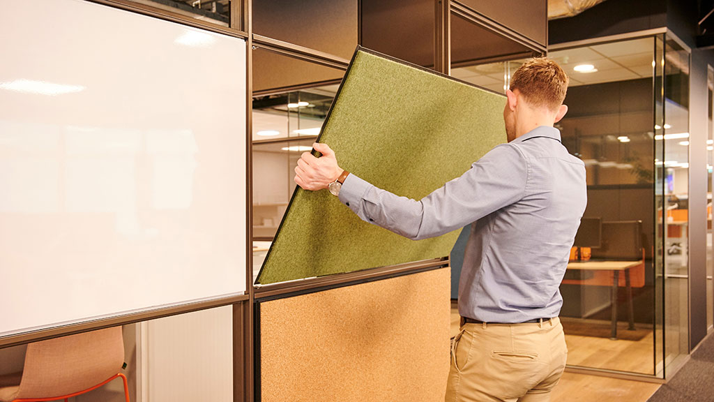 A man holding a green board.