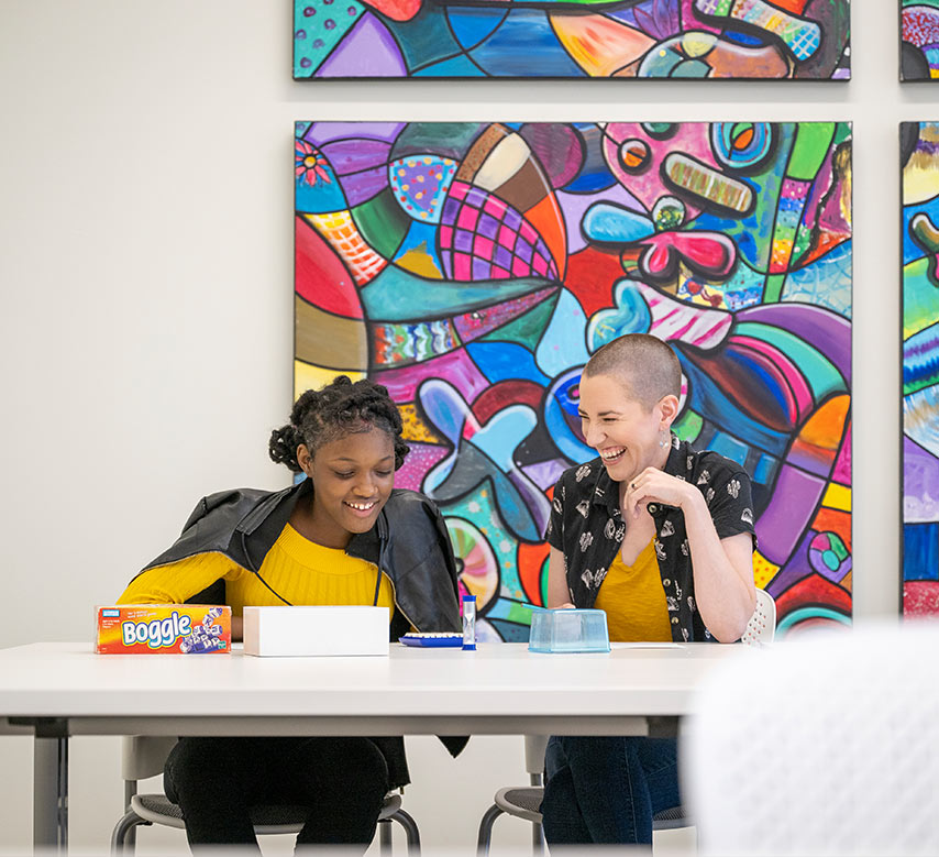 A mentor and mentee playing a game at Big Brothers Big Sisters Headquarters.
