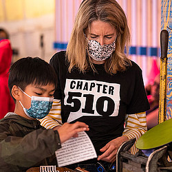 Chapter 510 volunteer and young boy working on a creative project