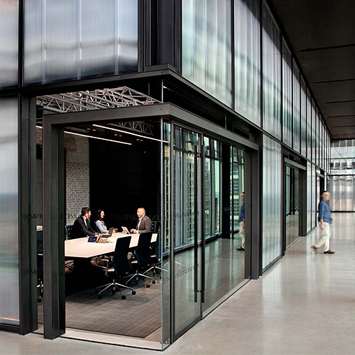 A group of people sitting at a table in a building.