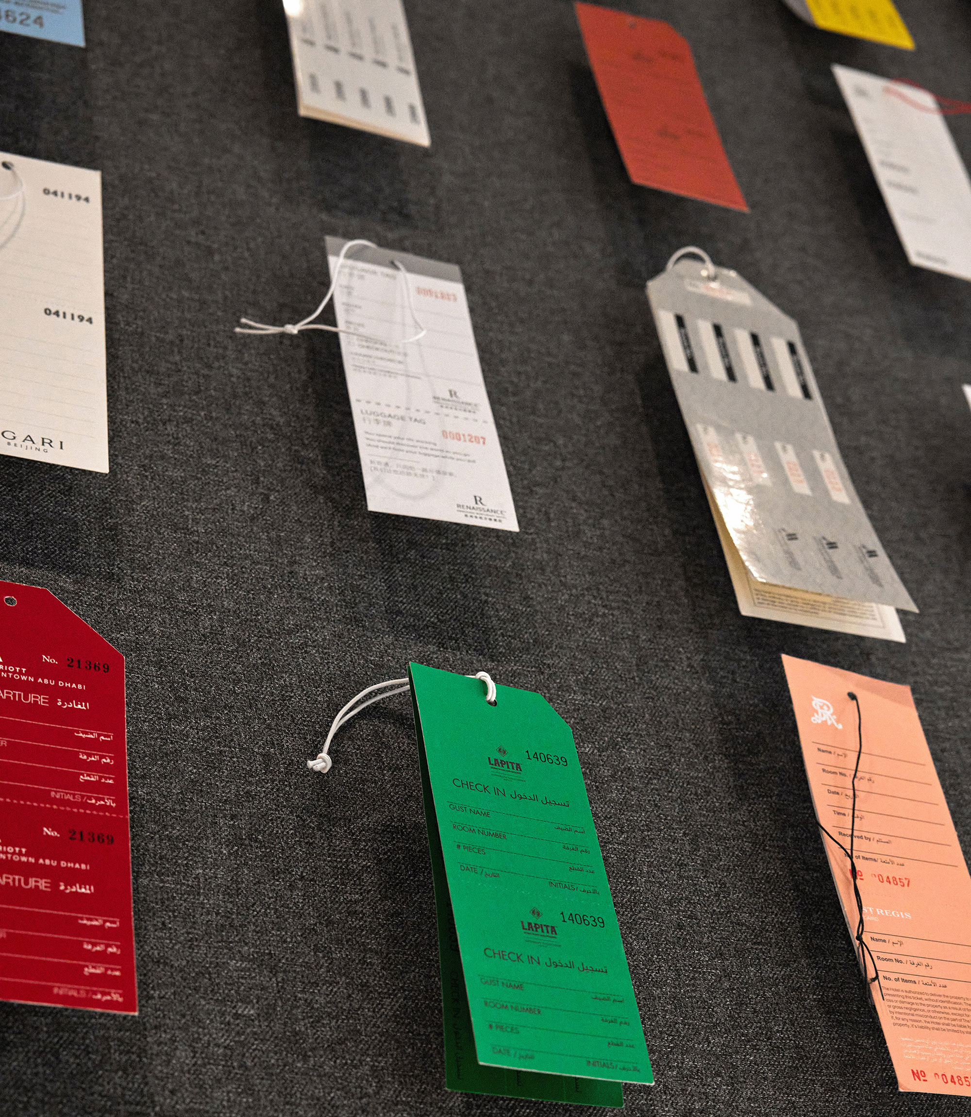 A group of hotel key cards on a wall.