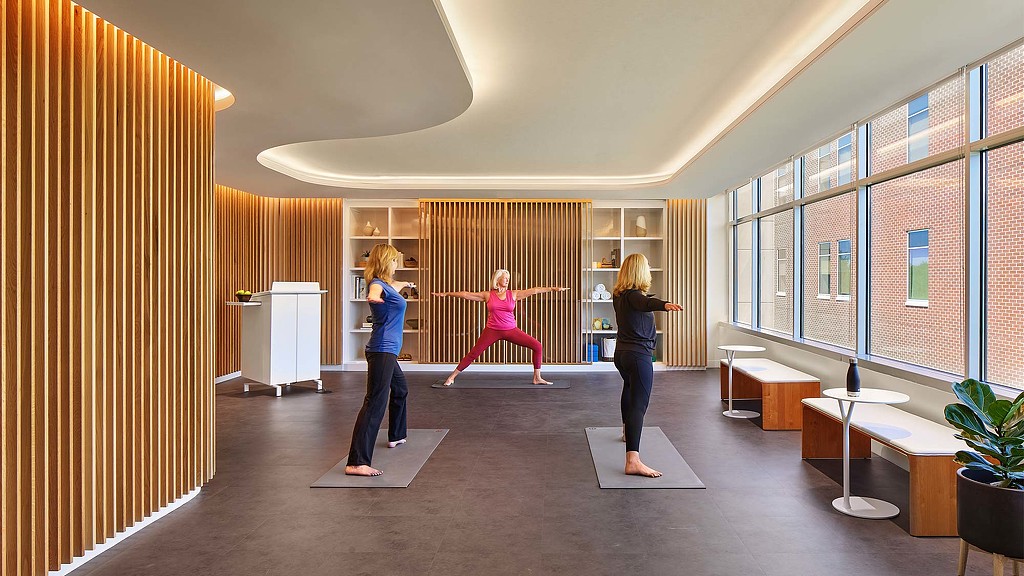 A group of people exercising in a room.
