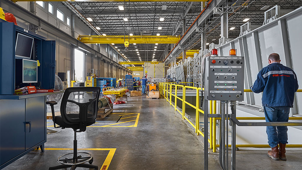 A person standing in a factory.