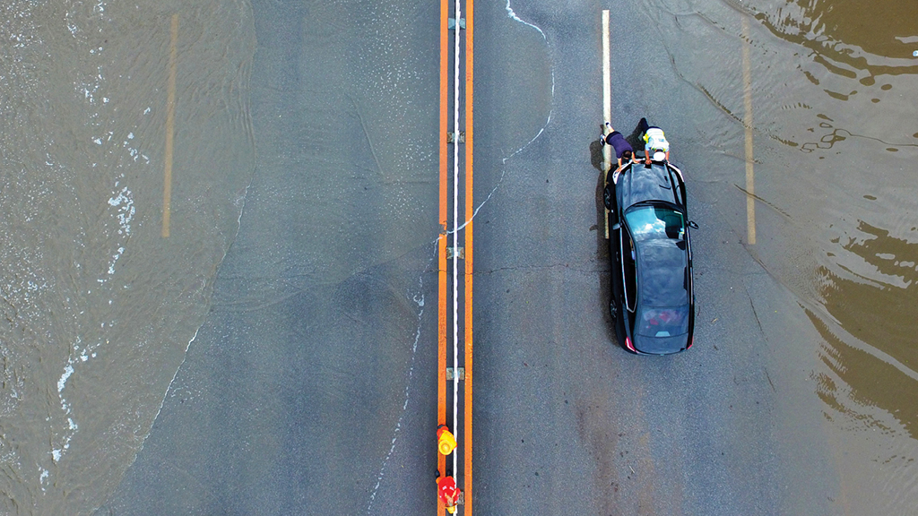 A person riding a car on a road.