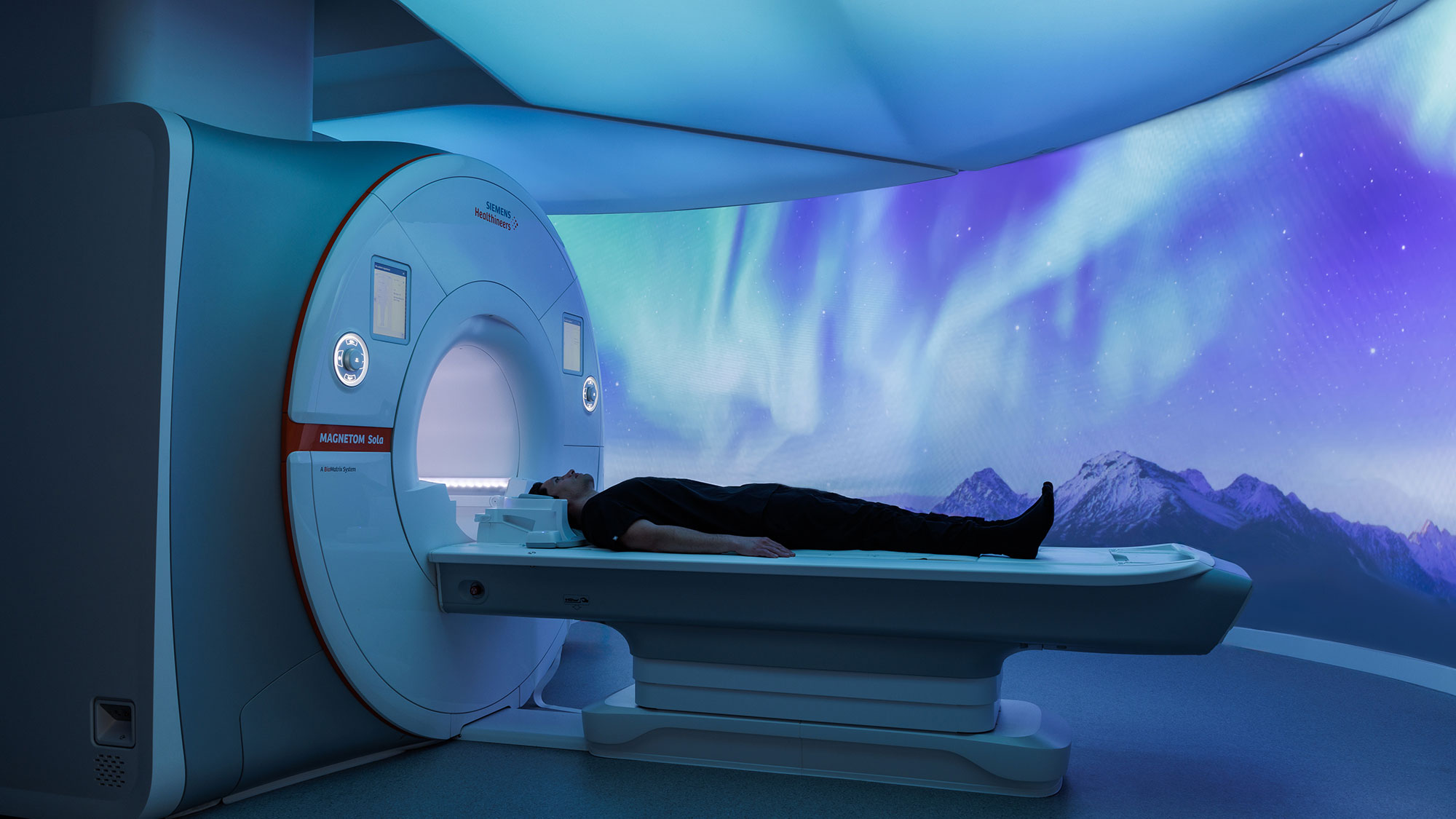 A person lying in a machine.