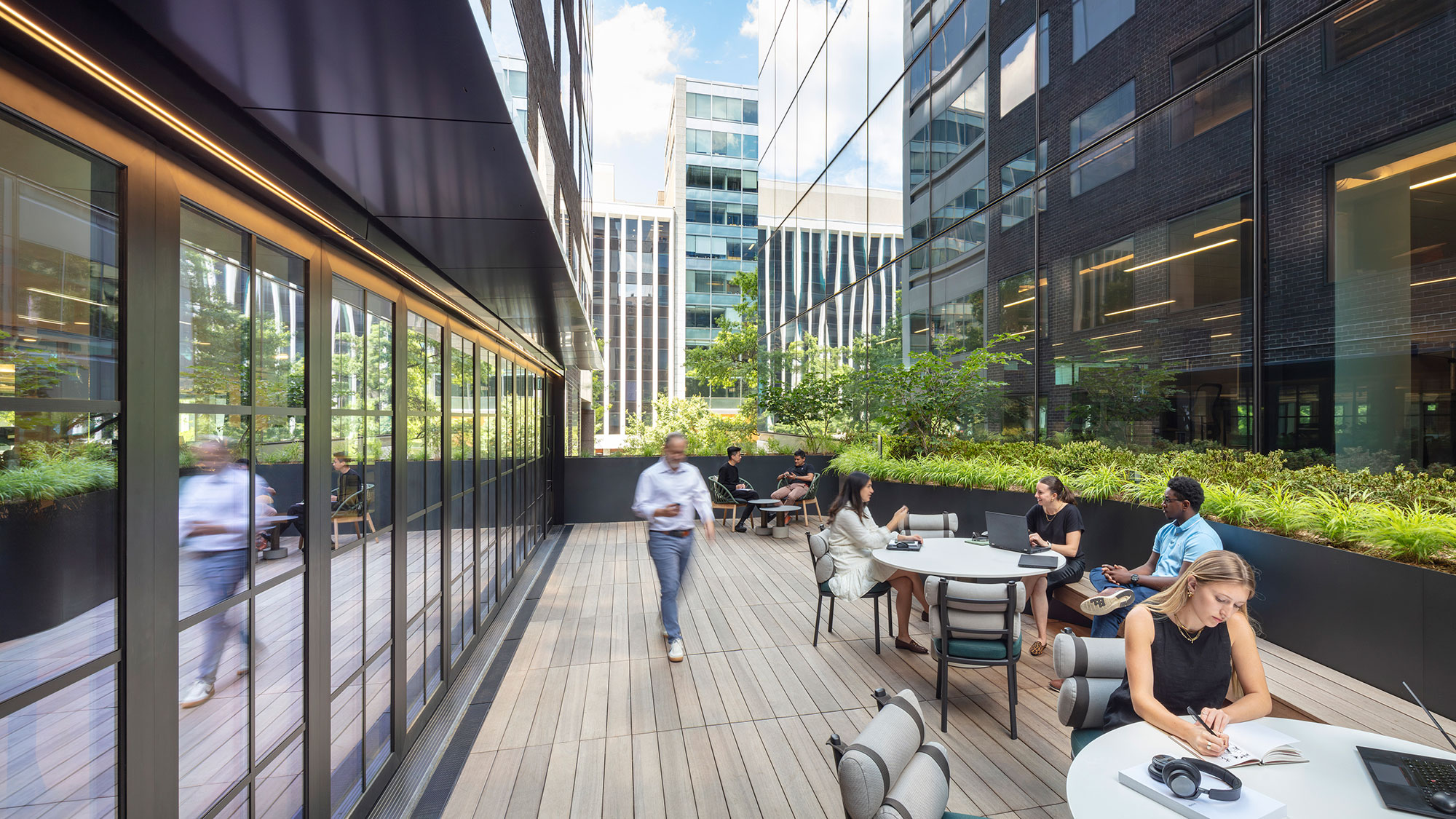 People sitting at tables outside a building.