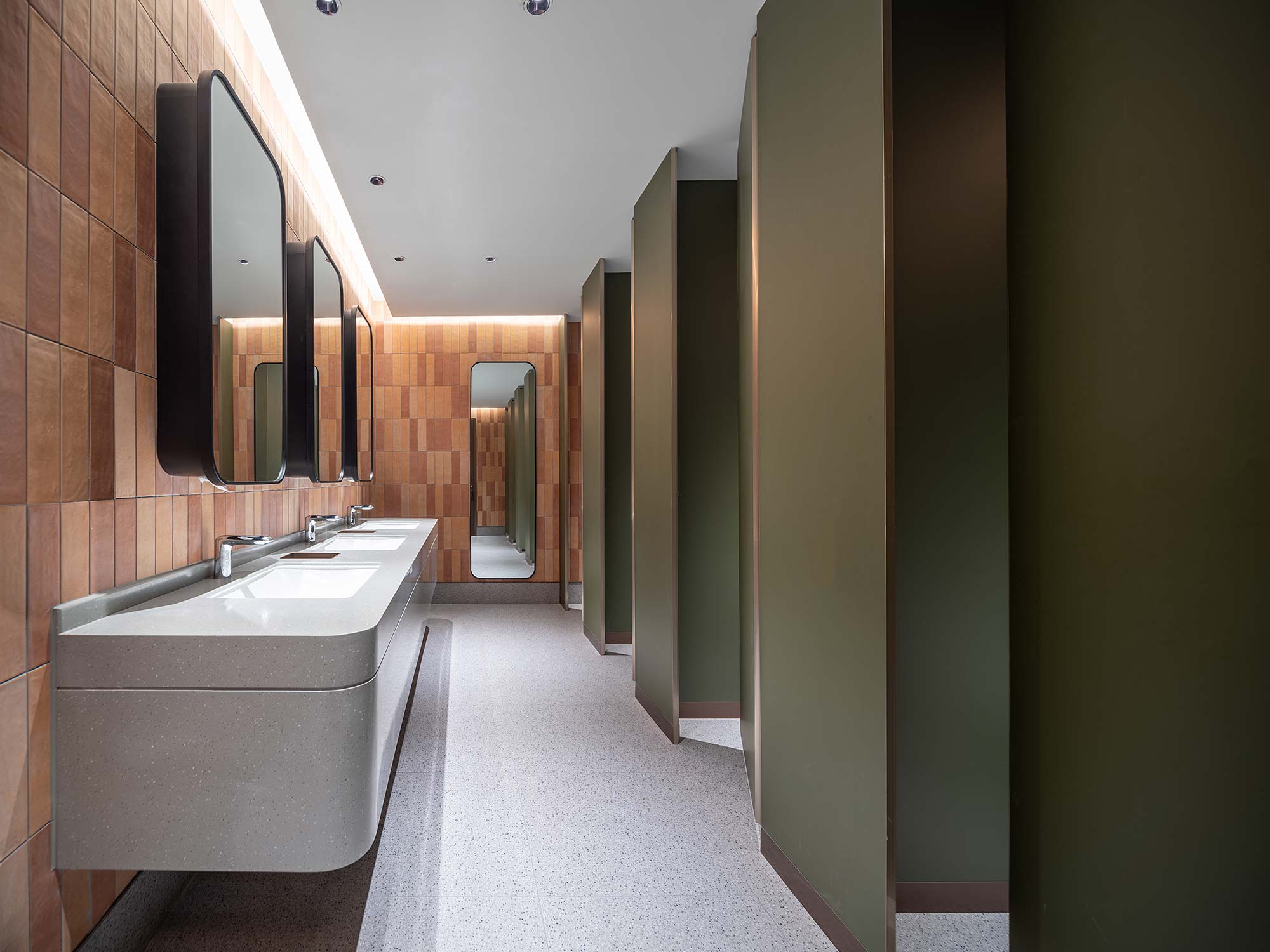 A bathroom with sinks and mirrors.