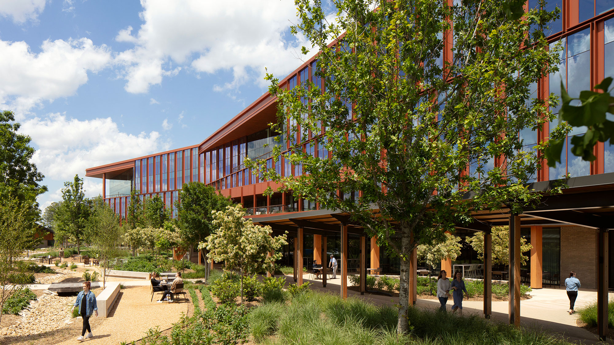 A building with trees and people outside.
